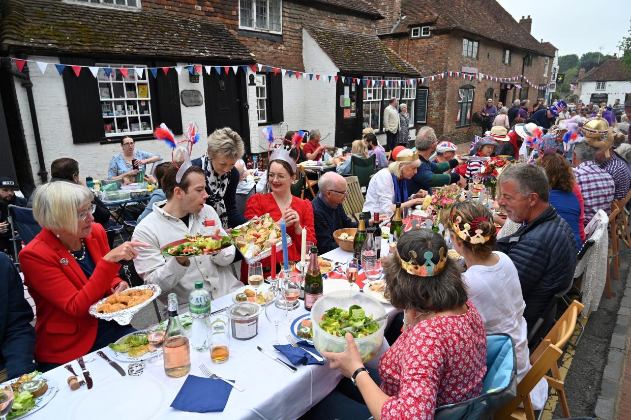 People attend a street party in Alfriston, East Sussex, on June 5, 2022 as part of Queen Elizabeth II's platinum jubilee celebrations. - Millions of people are expected to attend 