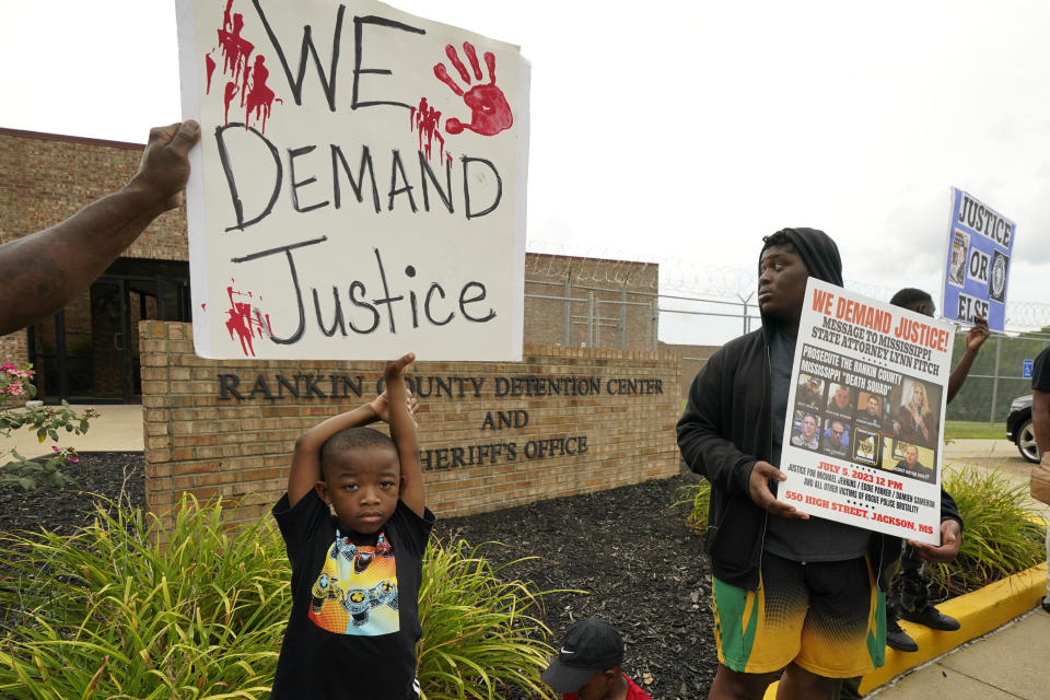 FILE - An anti-police brutality activist looks back at the entrance to the Rankin County Sheriff's Office in Brandon, Miss., Wednesday, July 5, 2023, as the group called for the termination and prosecution of Rankin County Sheriff Bryan Bailey for running a law enforcement department that allegedly terrorizes and brutalizes minorities. Six white former law enforcement officers in Mississippi have pleaded guilty to a racist assault on Michael Corey Jenkins and his friend Eddie Terrell Parker, who are Black. (AP Photo/Rogelio V. Solis, File)