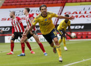 Arsenal's Dani Ceballos, front, celebrates after scoring his side's second goal during the FA Cup sixth round soccer match between Sheffield United and Arsenal at Bramall Lane in Sheffield, England, Sunday, June 28, 2020. (Andrew Boyers/Pool via AP)