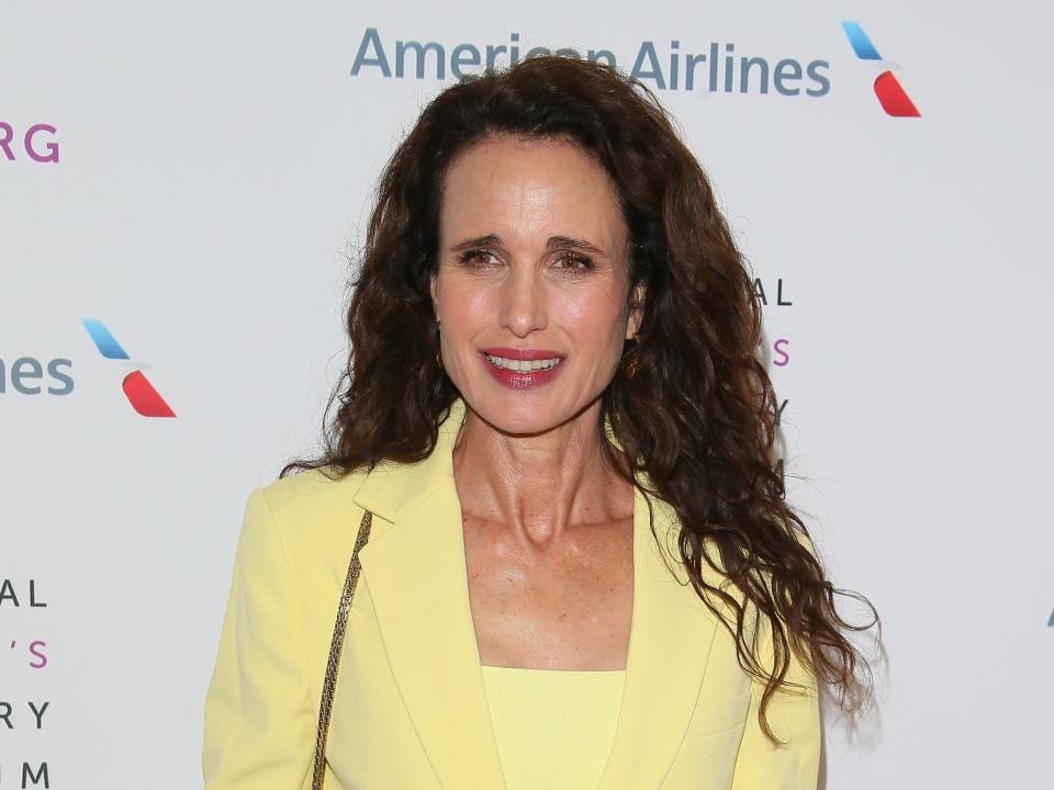 Andie MacDowell in a yellow suit