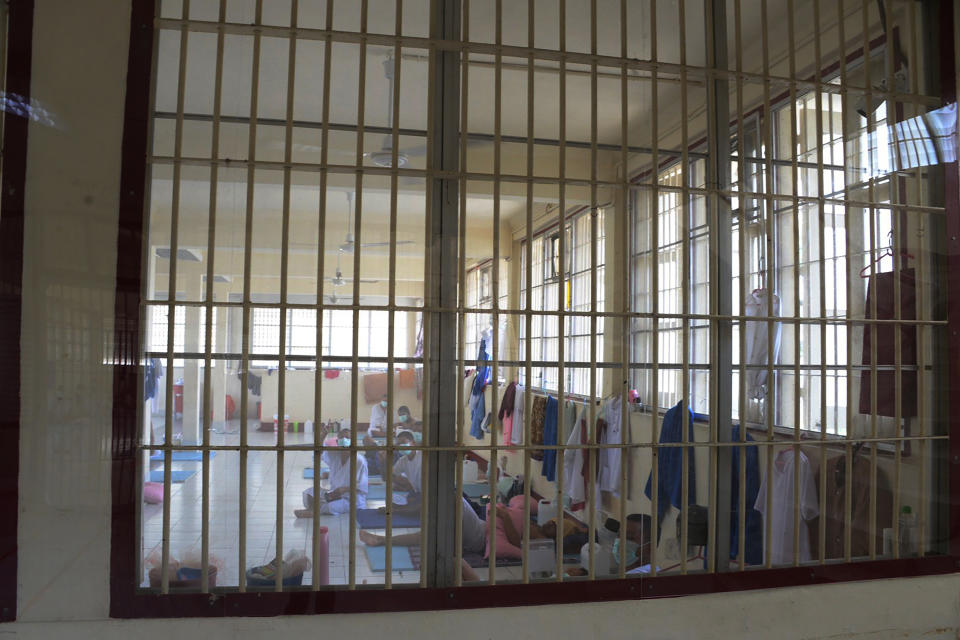 In this photo released by Department of Corrections, COVID-19 prisoners sit inside a field hospital set up at Medical Correctional Institution to treat COVID-19 inmates, in Bangkok, Thailand, on May 8, 2021. Almost 3,000 inmates incarcerated at two prisons in Thailand’s capital Bangkok have tested positive for COVID-19, the Corrections Department said Wednesday, May 12, 2021 as the Southeast Asian nation battles a virulent third wave of the coronavirus. (Department of Corrections, Thailand via AP)