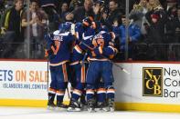 Feb 9, 2019; Brooklyn, NY, USA; New York Islanders defenseman Ryan Pulock (6) celebrates with teammates after scoring in overtime against the Colorado Avalanche at Barclays Center. Mandatory Credit: Catalina Fragoso-USA TODAY Sports
