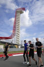 Alpine driver Esteban Ocon, third from right, of France, walks the course with his crew before the Formula One U.S. Grand Prix auto race at the Circuit of the Americas, Thursday, Oct. 21, 2021, in Austin, Texas. (AP Photo/Nick Didlick)