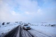 Cars are stuck in snow that fell overnight from Storm Arwen, in Leek