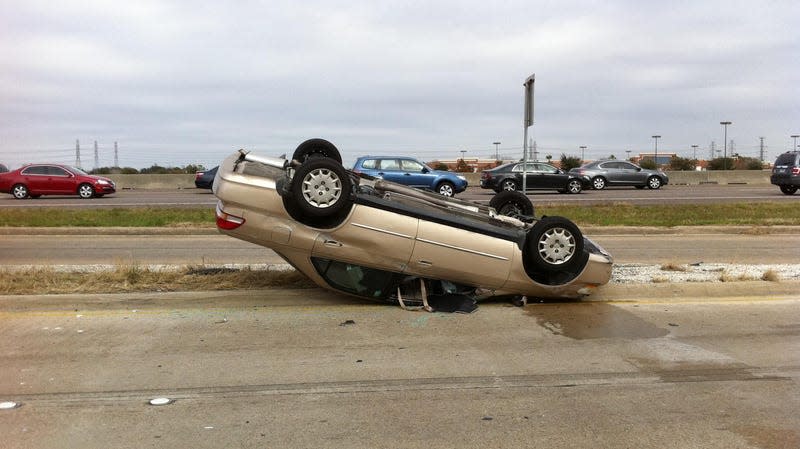 Car fallen upside-down on road in accident, Houston.