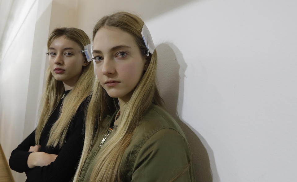 Models wait in the backstage prior to the start of the Fausto Puglisi women's Fall-Winter 2017-18 fashion show, that was presented in Milan, Italy, Wednesday, Feb. 22, 2017. (AP Photo/Luca Bruno).