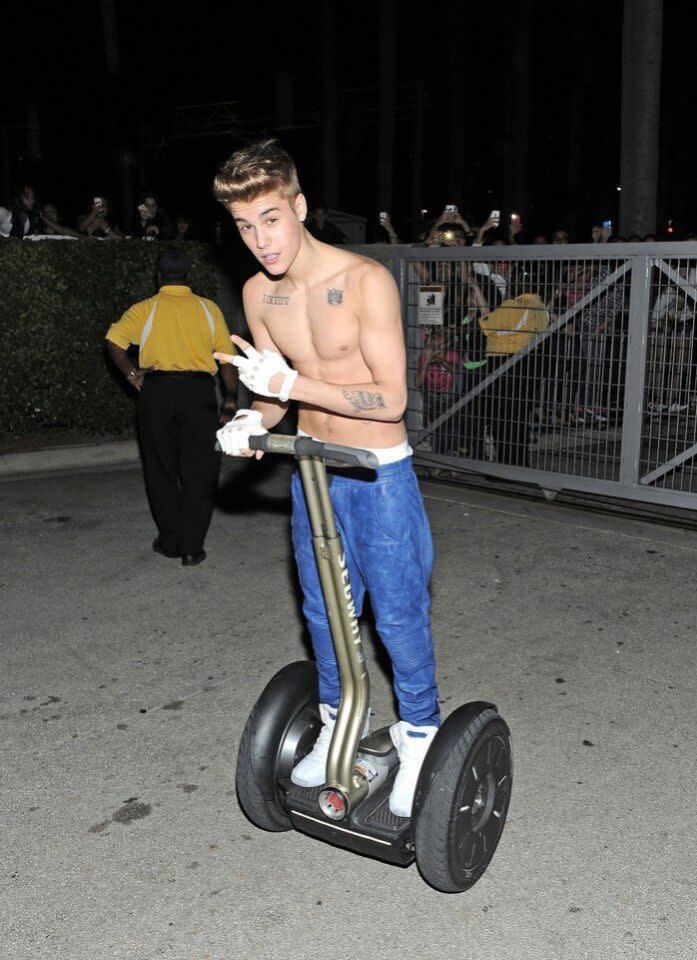 Listen guys: Justin was absolutely not trying to attract attention while shirtless and riding a Segway outside a concert venue as hundreds of Beliebers screamed at him from behind a barrier. (Photo: Twitter)