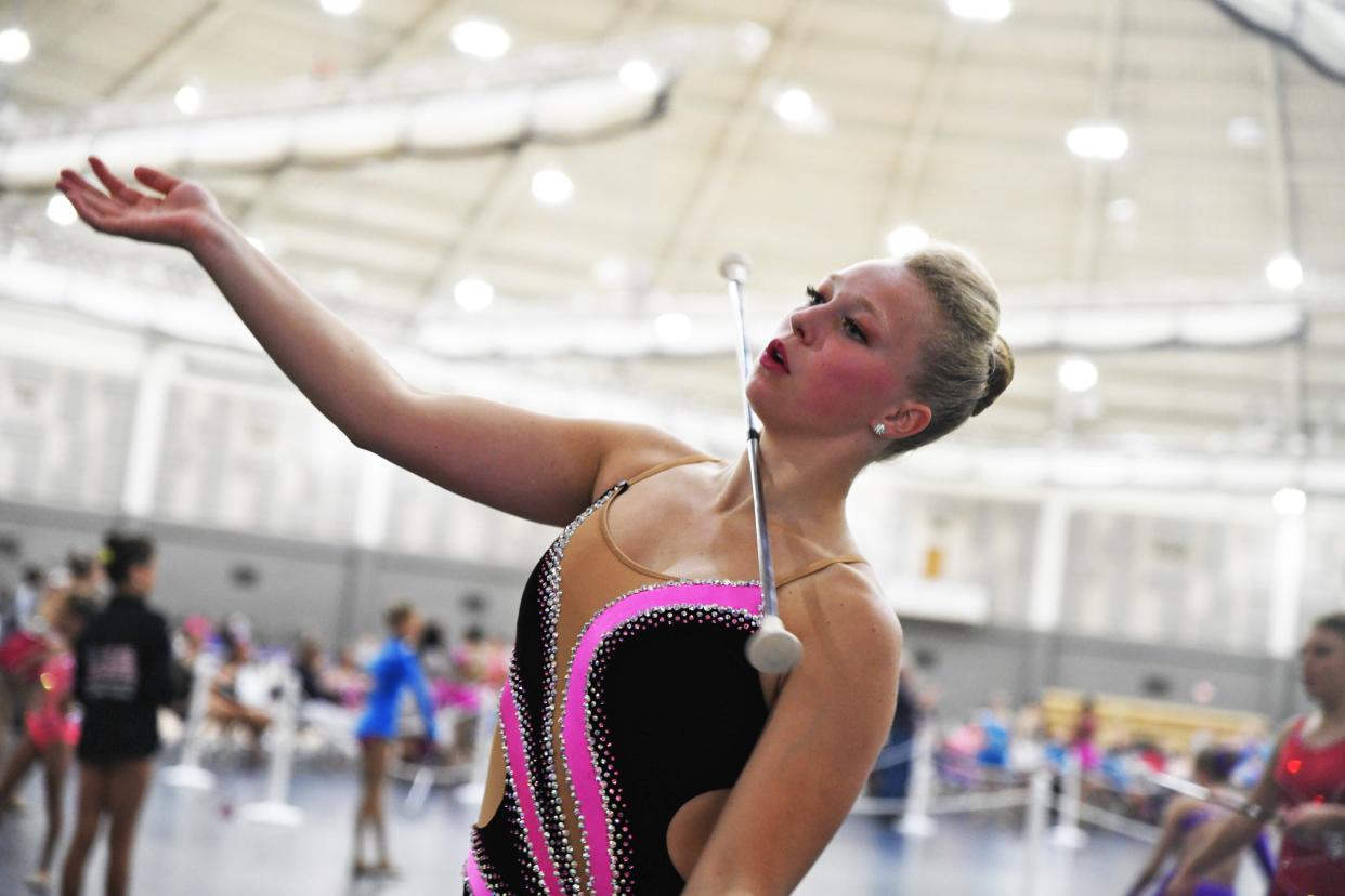 Kylie Cates, 22, from Canton, Ohio, performs a monster twirl in preparation for her performance in the annual America's Youth on Parade baton twirling competition at the University of Notre Dame in South Bend on July 25, 2023. She has been twirling in competitions since she was 2 years old.