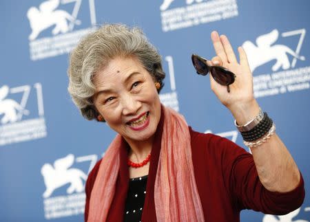 Cast member Lu Zhong poses during the photo call for the movie "Chuangru zhe" (Red amnesia) at the 71st Venice Film Festival September 4 2014. REUTERS/Tony Gentile