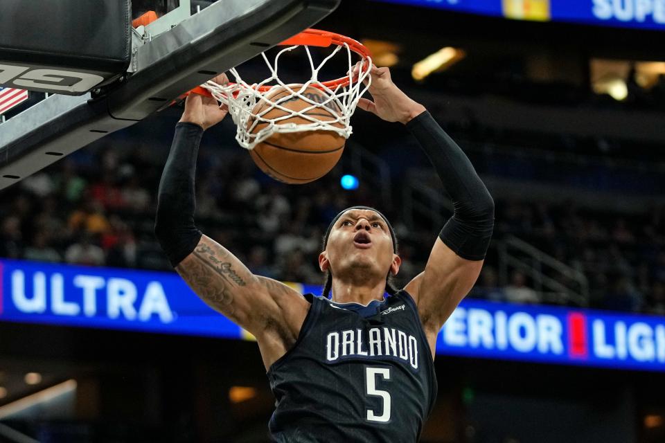 Orlando Magic's Paolo Banchero (5) makes an uncontested dunk against the Utah Jazz during the first half of an NBA basketball game, Thursday, March 9, 2023, in Orlando, Fla. (AP Photo/John Raoux)