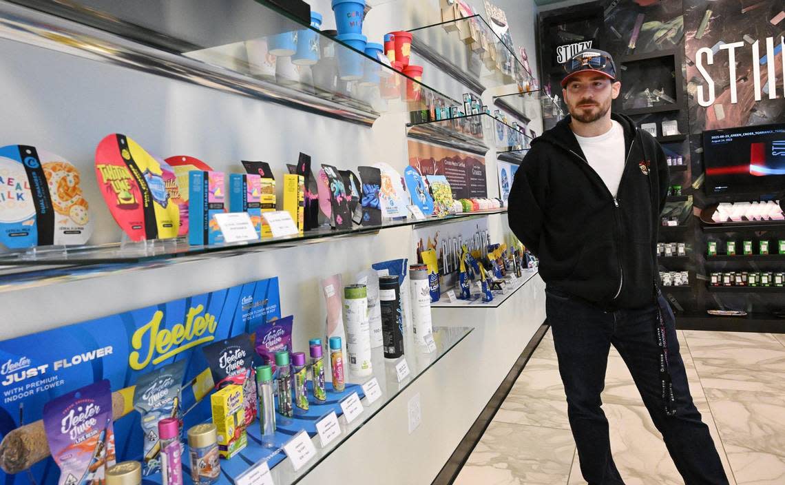 Josh Rogina looks over some of the product he sells at The Station, Fresno’s third and newest cannabis dispensary located in a former bank on Shaw Ave. across from Fashion Fair. Photographed Tuesday, Dec. 5, 2023 in Fresno. ERIC PAUL ZAMORA/ezamora@fresnobee.com