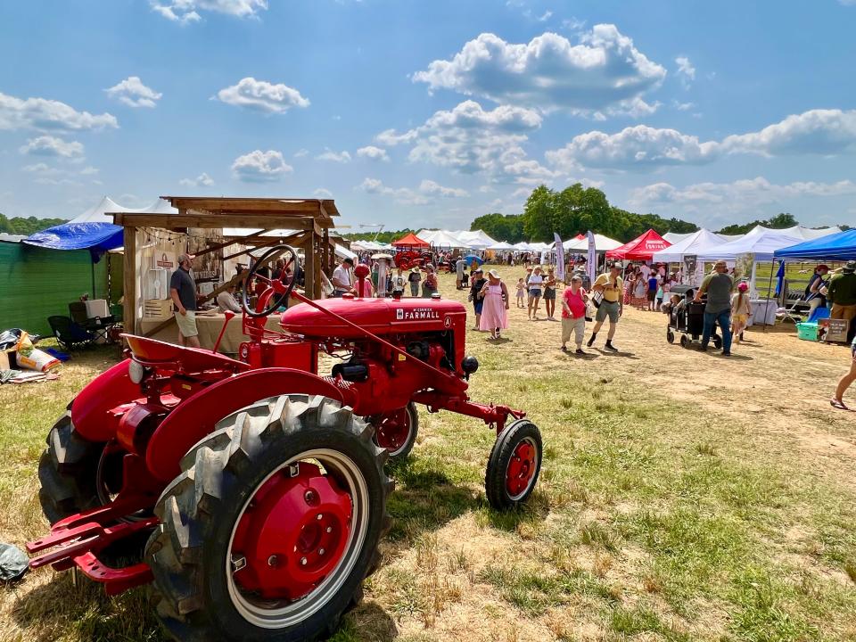 A vintage Farmall tractor leads the way to one of the vendor areas featured at the second annual Homestead Festival.