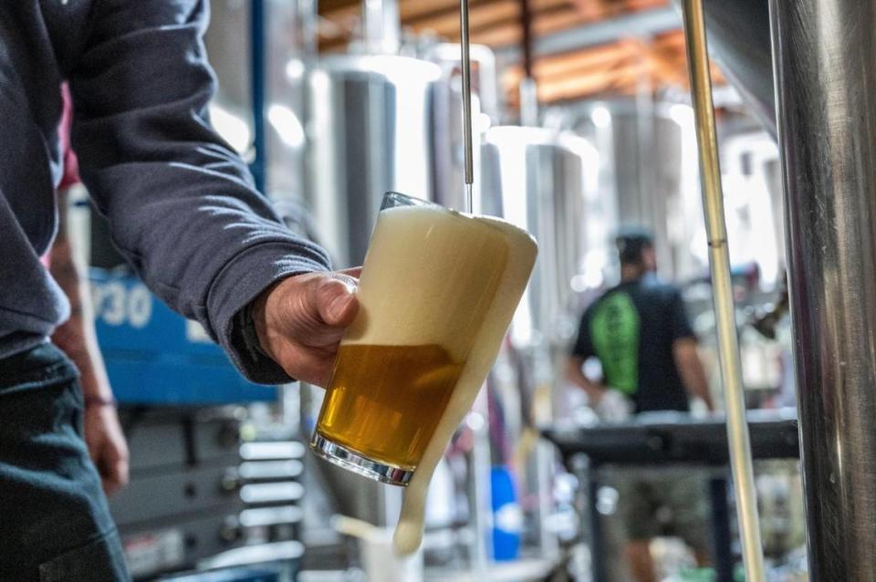 Robert Moreno, head brewer at Jackrabbit Brewing, where Onibi Japanese-inspired craft beer is made in West Sacramento, pours some of the beer he’s making for tasting on Monday, April 18, 2022.