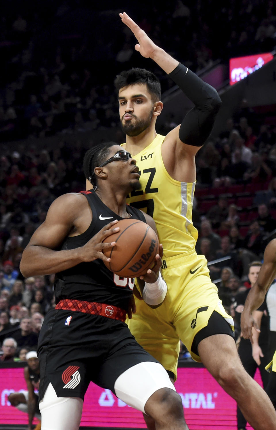 Portland Trail Blazers guard Scoot Henderson, left, drives to the basket against Utah Jazz center Omer Yurtseven, right, during the first half of an NBA basketball game in Portland, Ore., Wednesday, Nov. 22, 2023. (AP Photo/Steve Dykes)