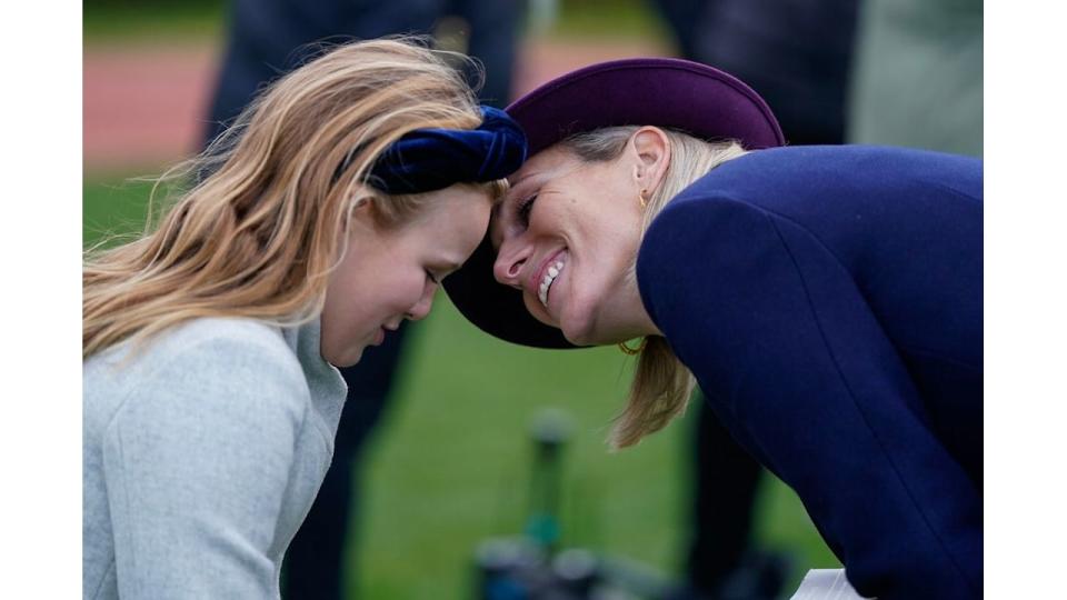 Zara Tindall with her head close to Mia Tindall's