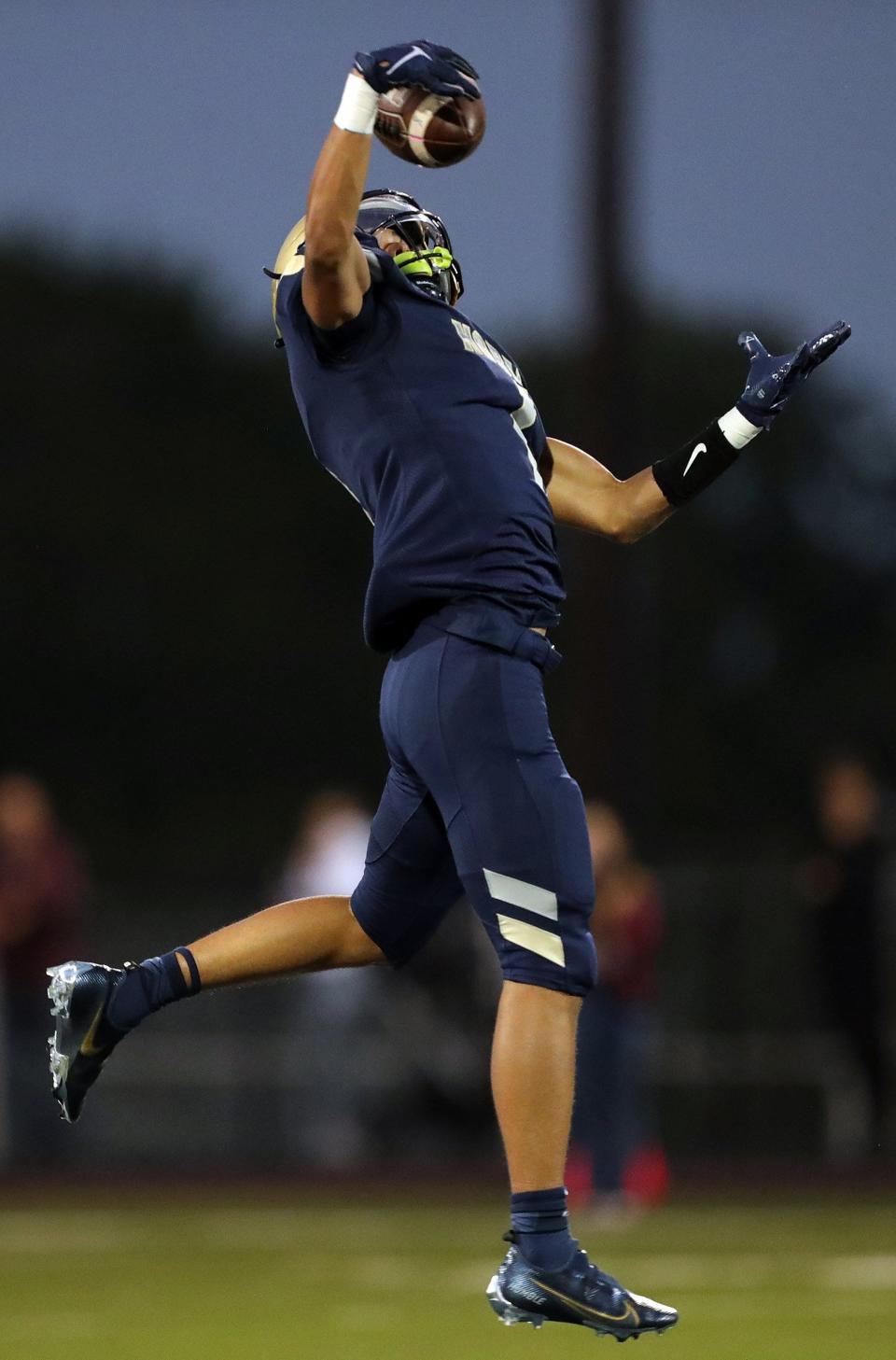 Hoban defensive back Tysen Campbell picks off a pass before returning it for a touchdown against Walsh Jesuit during the first half of a high school football game, Friday, Sept. 29, 2023, in Akron, Ohio.