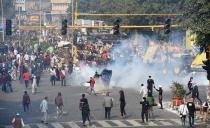 NEW DELHI, INDIA - JANUARY 26: Tear gas fired by police to stop protesting farmers on tractors after they entered the city on Republic Day at ITO on January 26, 2021 in New Delhi, India. Major scenes of chaos and mayhem at Delhi borders as groups of farmers allegedly broke barricades and police check posts and entered the national capital before permitted timings. Police used tear gas at Delhi's Mukarba Chowk to bring the groups under control. Clashes were also reported at ITO, Akshardham. Several rounds of talks between the government and protesting farmers have failed to resolve the impasse over the three farm laws. The kisan bodies, which have been protesting in the national capital for almost two months, demanding the repeal of three contentious farm laws have remained firm on their decision to hold a tractor rally on the occasion of Republic Day.(Photo by Arvind Yadav/Hindustan Times via Getty Images)