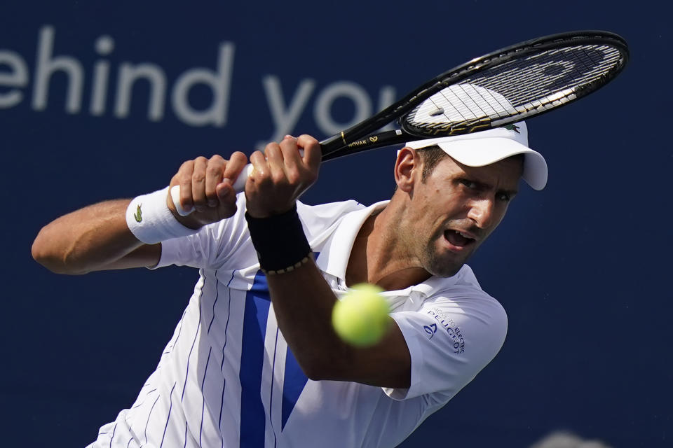 Novak Djokovic, of Serbia, returns a shot from Tennys Sandgren during the third round at the Western & Southern Open tennis tournament Tuesday, Aug. 25, 2020, in New York. (AP Photo/Frank Franklin II)