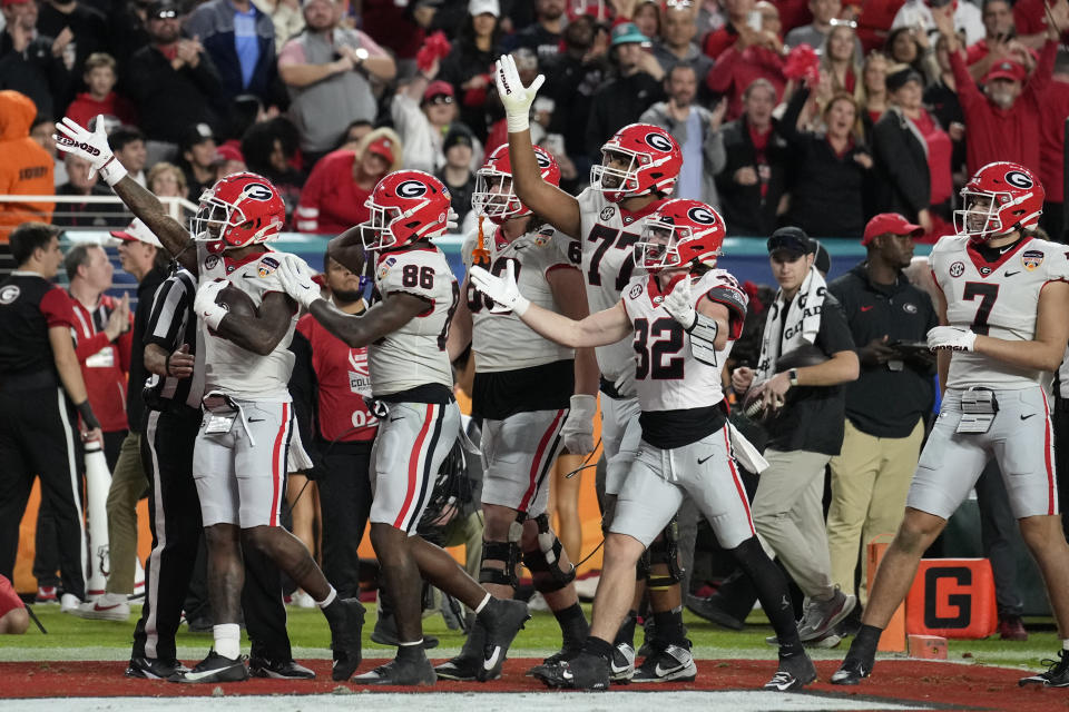 Teammates celebrate a touchdown by Georgia wide receiver Dominic Lovett (6), left, in the first half of the Orange Bowl NCAA college football game against Florida State, Saturday, Dec. 30, 2023, in Miami Gardens, Fla. (AP Photo/Rebecca Blackwell)