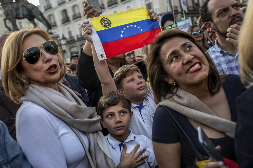 Supporters of Venezuelan opposition leader Juan Guaido gather in Madrid, Spain, Tuesday, April 30, 2019. Thousands of Venezuelans have migrated to Spain in recent years or are seeking asylum in the country, including prominent members of the opposition and former officials who worked closely with late Venezuelan President Hugo Chavez. More than 177,000 Spaniards live in Venezuela. (AP Photo/Bernat Armangue)