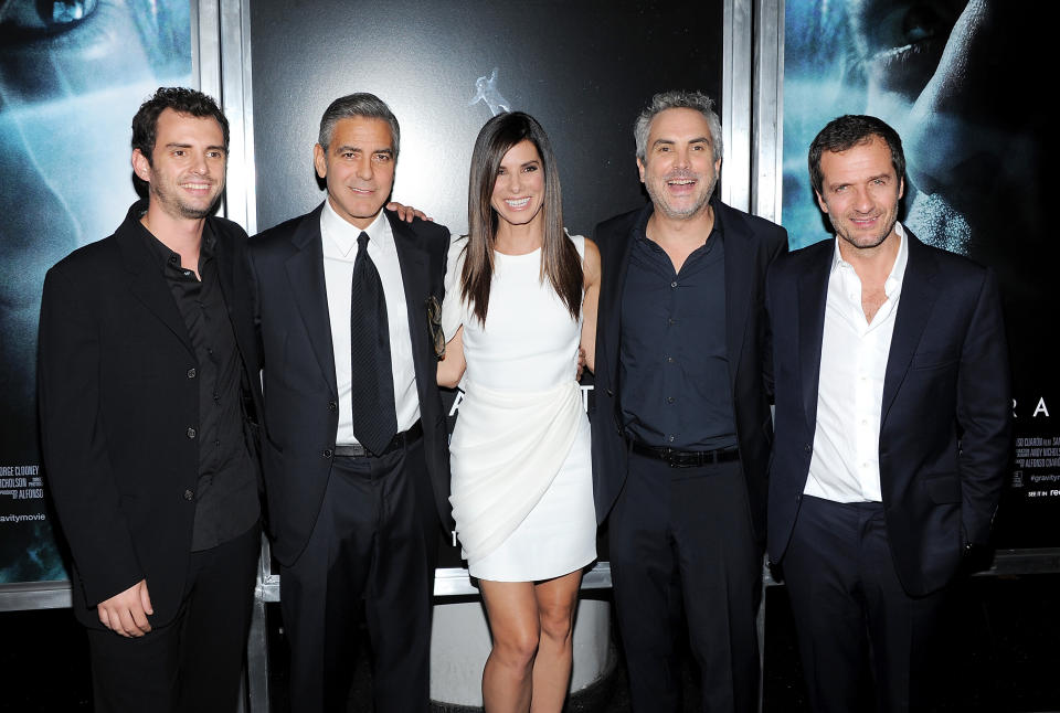 FILE - In this Oct. 1, 2013 file photo, from left, screenwriter Jonas Cuaron, actor George Clooney, actress Sandra Bullock, director Alfonso Cuaron and producer David Heyman pose together at the premiere of "Gravity" at the AMC Lincoln Square Theaters, in New York. Author Tess Gerritsen is suing the studio behind the hit film “Gravity” claiming it is based on one of her novels. Gerritsen’s lawsuit filed Tuesday, April 29, 2014, against Warner Bros. Entertainment Inc. seeks more than $10 million from the studio behind the Oscar-winning film, which starred Sandra Bullock. (Photo by Evan Agostini/Invision/AP, file)