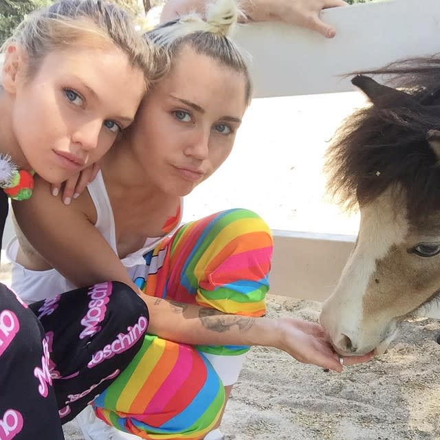 Miley Cyrus obviously isn't shy about packing on the PDA with her new love, Victoria's Secret model Stella Maxwell! The 22-year-old "Wrecking Ball" singer and the 24-year-old stunner have been showing off their relationship on social media for the past few months, but the pair took it to the next level on Tuesday, when they were spotted getting hot and heavy on the Hollywood set of an upcoming music video. Wearing a sparkly gold minidress and over-the-knee black boots, Miley embraced Stella while making out, and at one point, it appears her hand wanders down Stella's pants. <strong>WATCH: Meet Miley Cyrus' New Love, Stella Maxwell</strong> AKM/GSI Stella, who originally hails from New Zealand, recently told <em>V</em> magazine that the two met through Miley's close friend/assistant Cheyne Thomas, and have been hanging out since March. Miley split with her ex, Patrick Schwarzenegger, in April. Miley revealed she told her mother, Tish Cyrus, that she started having romantic feelings towards women at 14 years old in a candid interview with <em>Paper</em> magazine last month. "I remember telling her I admire women in a different way," Miley recalled. "And she asked me what that meant. And I said, I love them. I love them like I love boys." <strong>WATCH: Miley Cyrus Doesn't Like Labels -- 'I'm Ready to Love Anyone'</strong> Watch below: