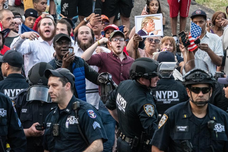 Protesters and supporters of Trump are separated by the NYPD outside the Crotona Park rally venue (Getty Images)