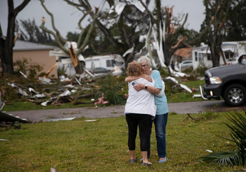 Residents of Century 21 in the Iona area embrace after confirmed tornado  touched down on Sunday, Jan. 16, 2022 in the Iona area.