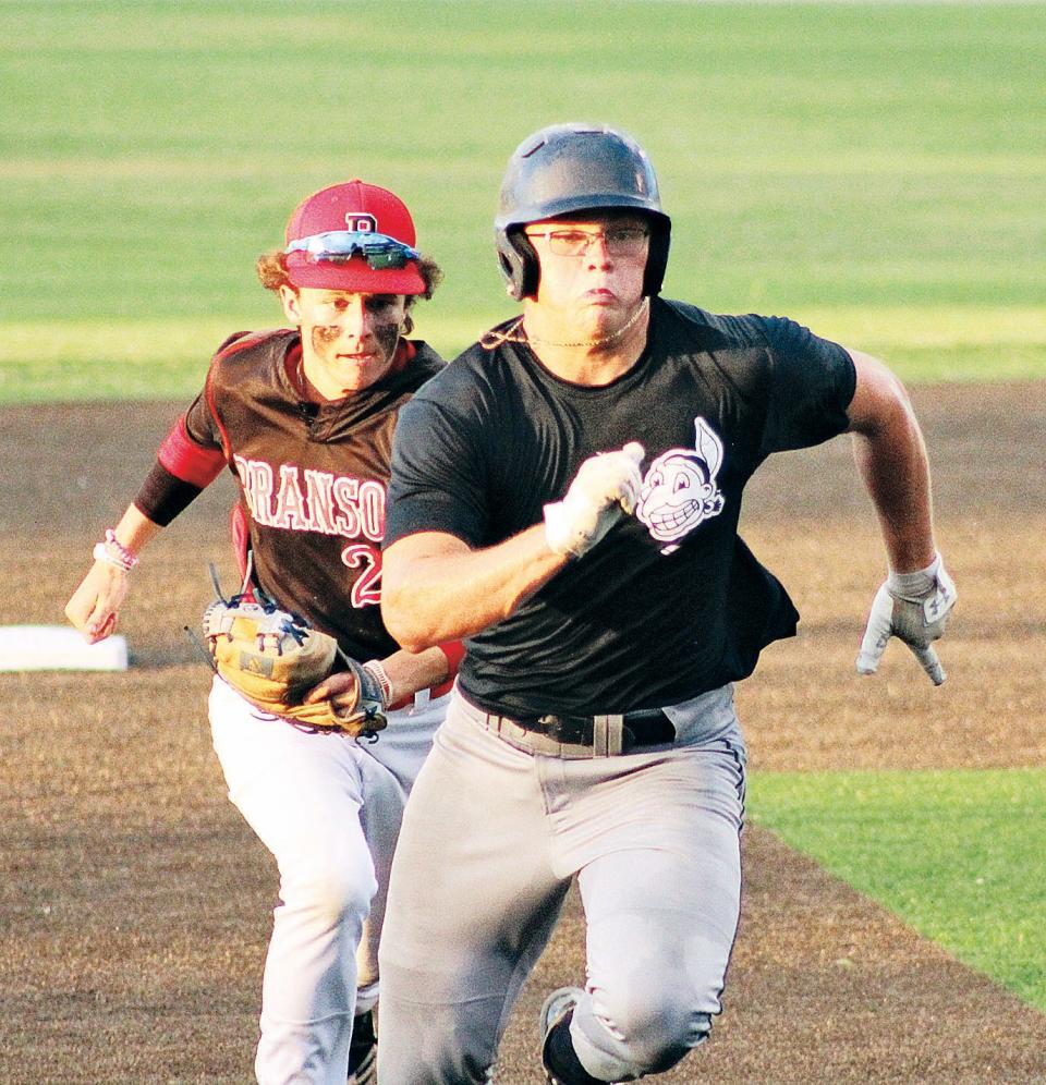 A Bartlesville Doenges Ford Indian baserunner, right, moves into over-drive to avoid a tag during 2020 Winget tourney action.