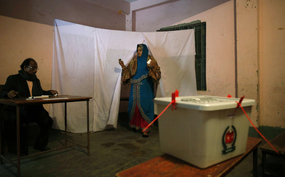 A Bangladeshi woman emerges from an enclosure after marking her ballot paper at a polling station in Dhaka, Bangladesh, Sunday, Jan. 5, 2014. Voting has started in Bangladesh for general elections Sunday that threaten to deepen the crisis in the South Asian nation. The opposition and its allies are boycotting the vote, a move that undermines the legitimacy of the election and makes it unlikely that the polls will stem a wave of political violence that killed at least 275 people in 2013. (AP Photo/ Rajesh Kumar Singh)