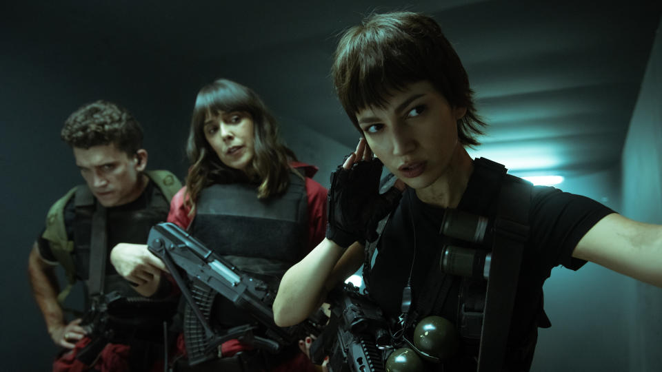 Cast of Money Heist Part 5: Volume 1 holds guns while in a secure vault. Image via Netflix