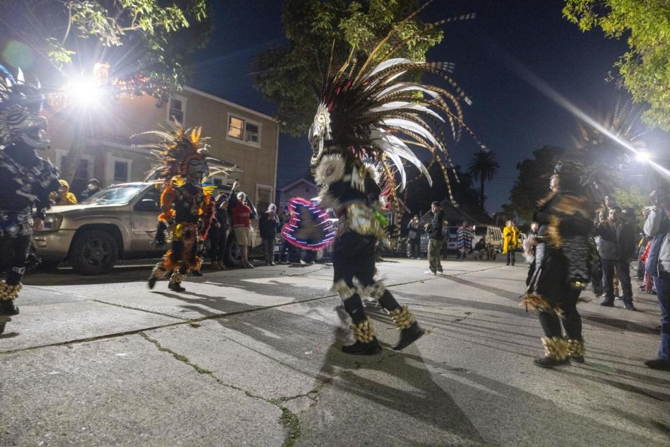 Crowds watch Aztec dancers perform in honor of the Virgen de Guadalupe