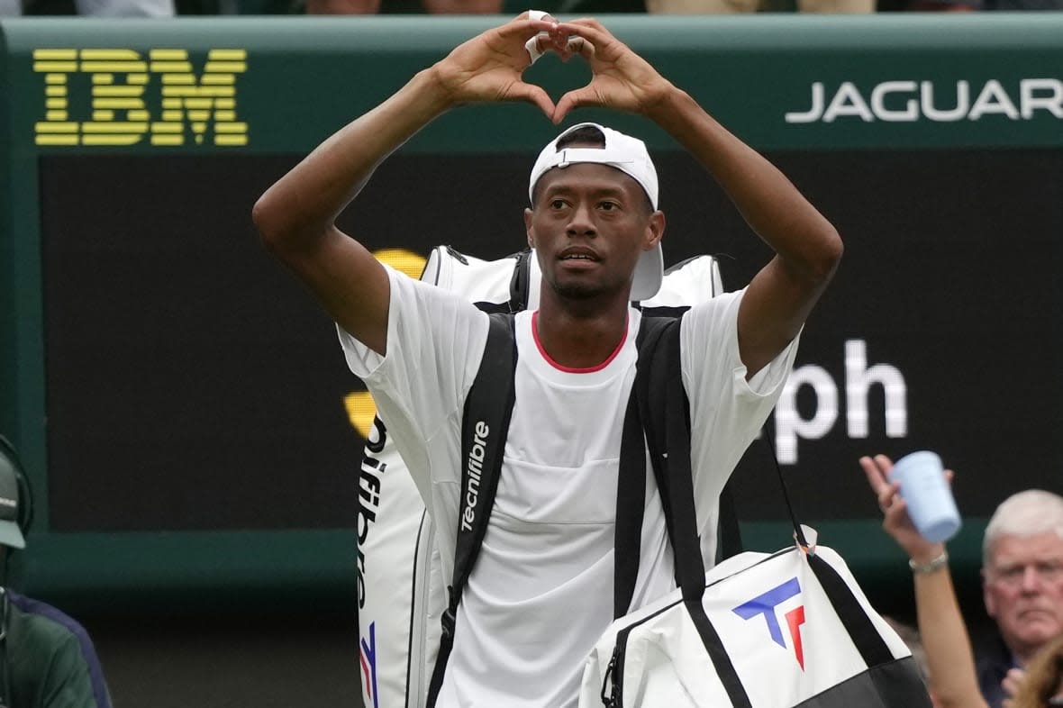 Christopher Eubanks of the US gestures to the crowd after losing to Russia’s Daniil Medvedev in their men’s singles match on day ten of the Wimbledon tennis championships in London, Wednesday, July 12, 2023. (AP Photo/Alastair Grant)