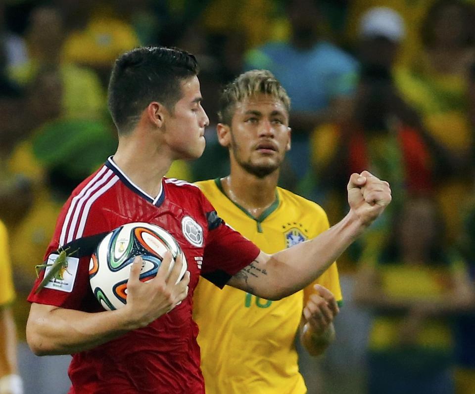 Colombia's James Rodriguez celebrates next to Brazil's Neymar after scoring a penalty against Brazil during their 2014 World Cup quarter-finals at the Castelao arena in Fortaleza July 4, 2014. REUTERS/Yves Herman (BRAZIL - Tags: SOCCER SPORT WORLD CUP TPX IMAGES OF THE DAY)