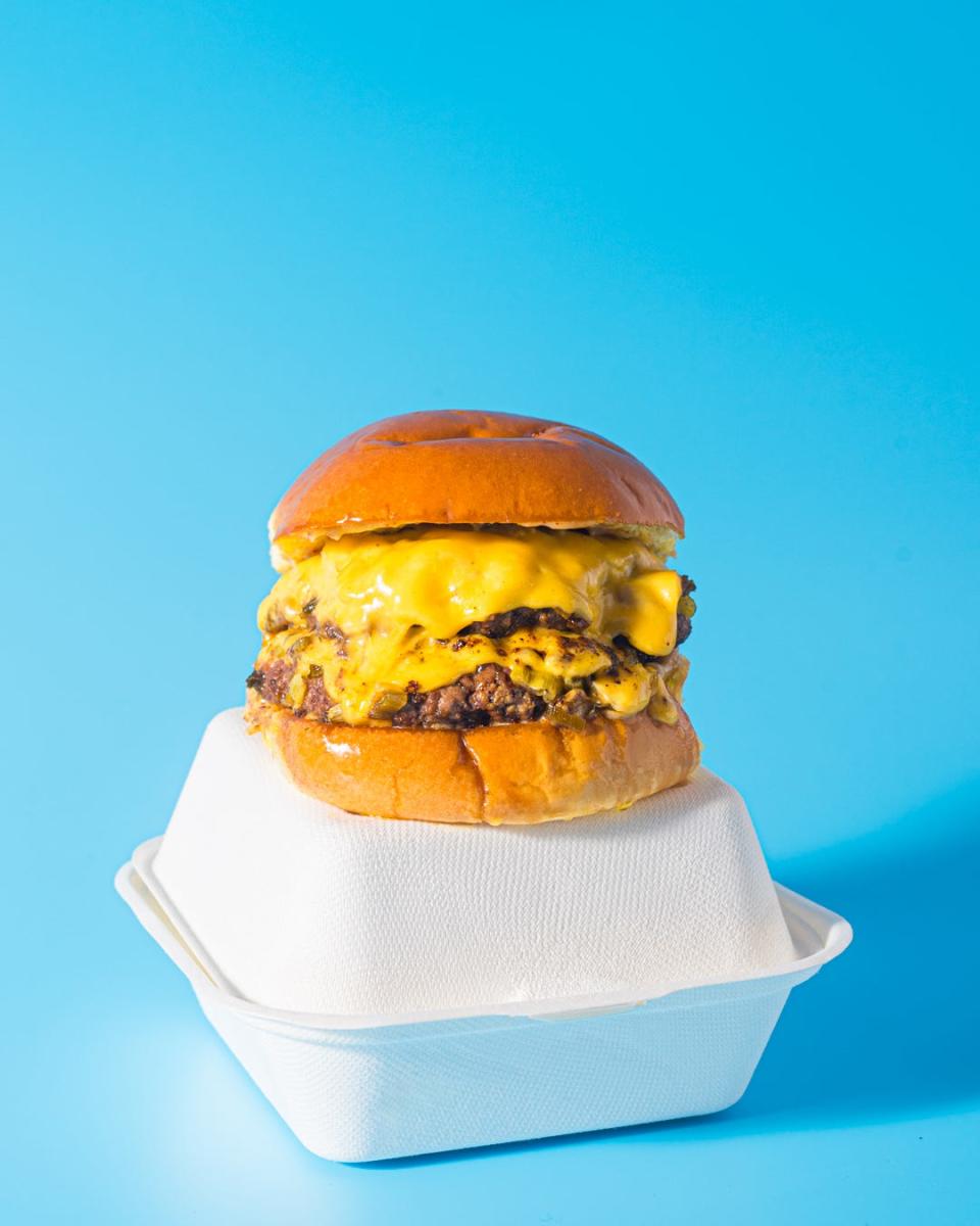 The Rebel Burger's signature burger is made with two smashed and charred beef patties and cheese on a brioche bun.