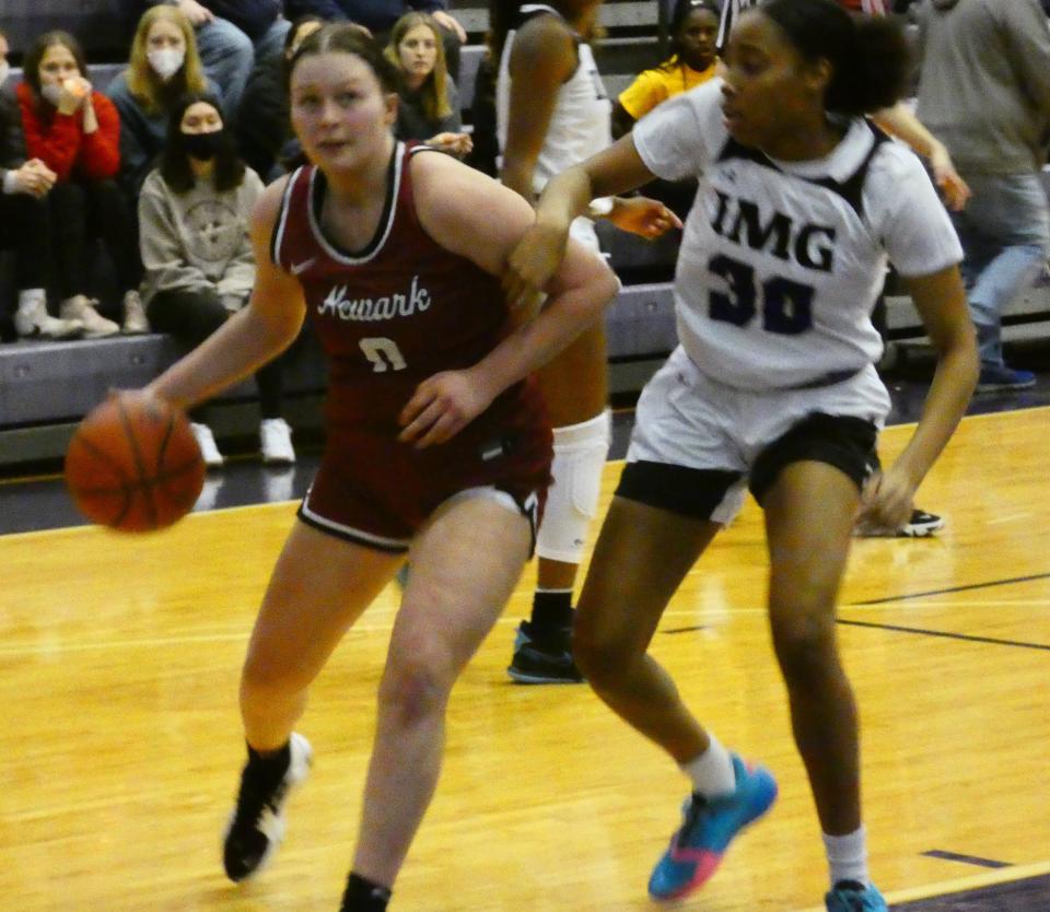 Newark junior Sophie Bidwell drives against IMG Academy's T'yana Todd during the Classic in the City at Pickerington Central on Saturday, Jan. 15, 2022. The Wildcats fell 54-37.