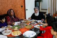 Ali Hasan Baqai, whose family was divided by the partition of the subcontinent in 1947, sits along with his wife Shaistan Ali and grand children to have lunch, at his home in Karachi