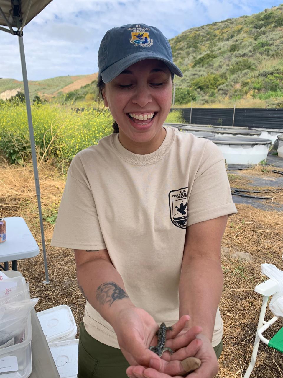 Felicia Aasand, this year's Kendra Chan Conservation fellow, holds a salamander in this photo. The fellowship was inspired by Chan, a biologist with the U.S. Fish and Wildlife Service, who died in the Conception dive boat fire in 2019.