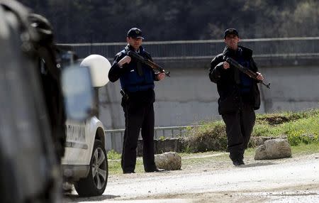 Police officers from special police units pass a checkpoint on the road to the village of Goshince from where police officers were taken hostage overnight, north of the capital Skopje April 21, 2015. REUTERS/Ognen Teofilovski