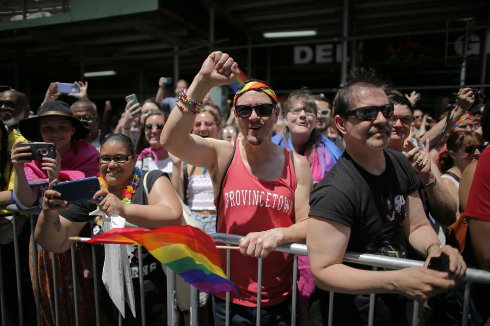 <p>Revelers standing on Seventh Avenue watch the annual Pride Parade on June 24, 2018 in New York City. (Photo: Kena Betancur/Getty Images) </p>