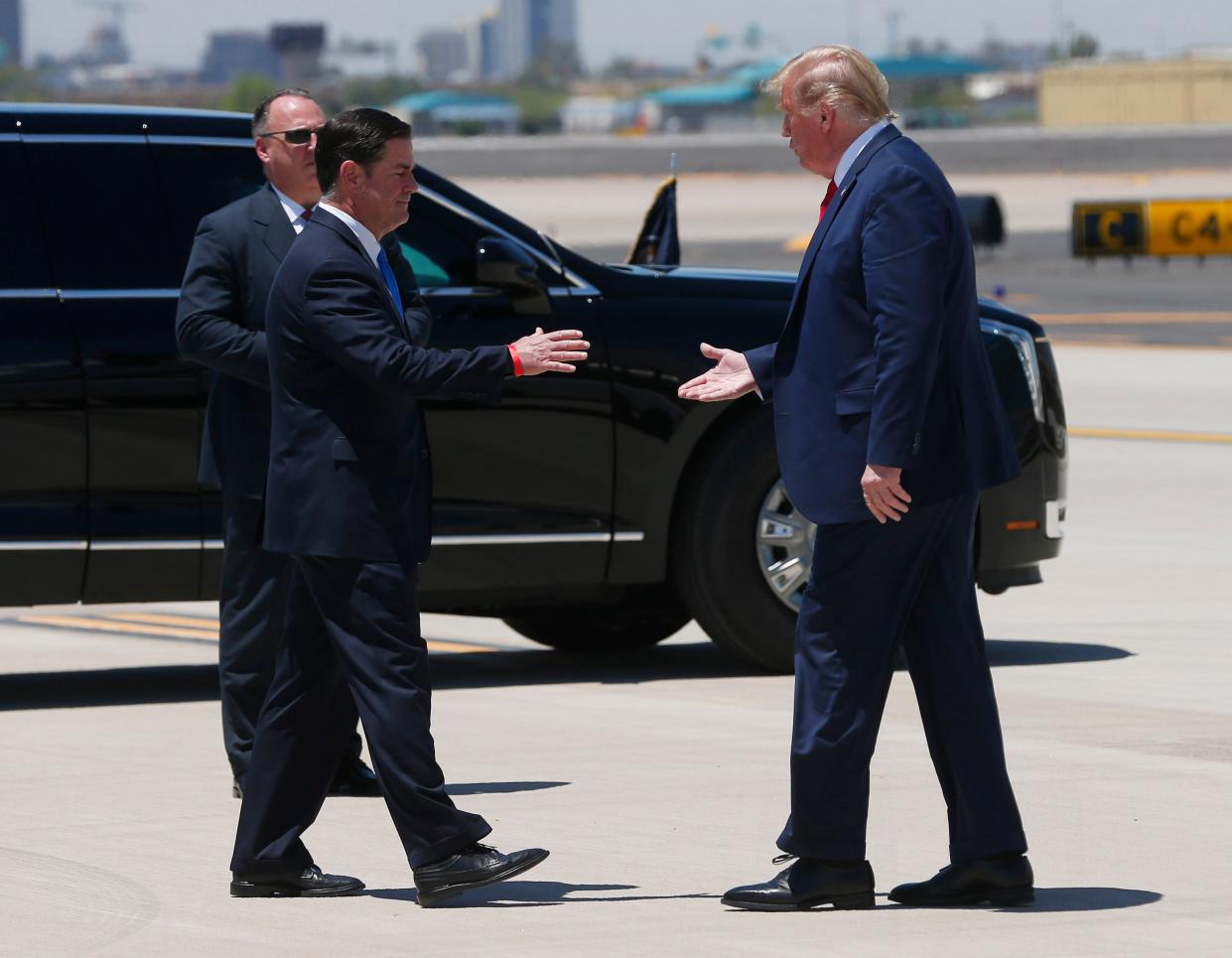 President Trump is greeted by Arizona Gov. Doug Ducey after landing at Phoenix Sky Harbor Airport for a visit to Honeywell Aerospace's mask-making operation in Phoenix on May 5, 2020.