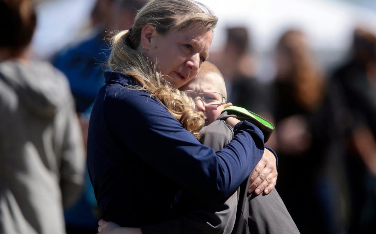 A mother and child embrace after a school shooting at Rigby Middle School in Rigby, Idaho - John Roark /The Idaho Post-Register 