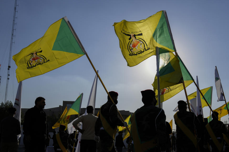 FILE - Fighters from the Popular Mobilization Forces attend the funeral of a commander from the Kataib Hezbollah paramilitary group killed in a U.S. airstrike, in Baghdad, Iraq on Feb. 8, 2024. The Popular Mobilization Forces are the owners of a basketball team in Iraq with Americans on the roster. (AP Photo/Hadi Mizban, File)