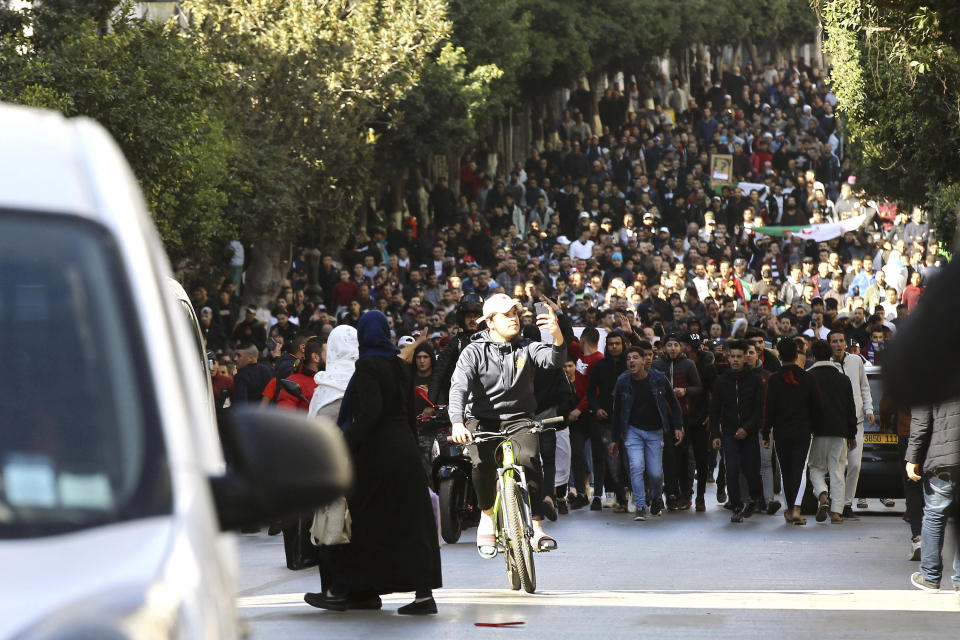 Demonstrators march in the streets of the Algerian capital, Algiers, to denounce President Abdelaziz Bouteflika's bid for a fifth term, Friday, Feb. 23, 2019. The 81-year-old Bouteflika announced this month that he plans to seek a new term in April presidential elections despite serious questions over his fitness for office after a 2013 stroke left him largely infirm. (AP Photo/Anis Belghoul)