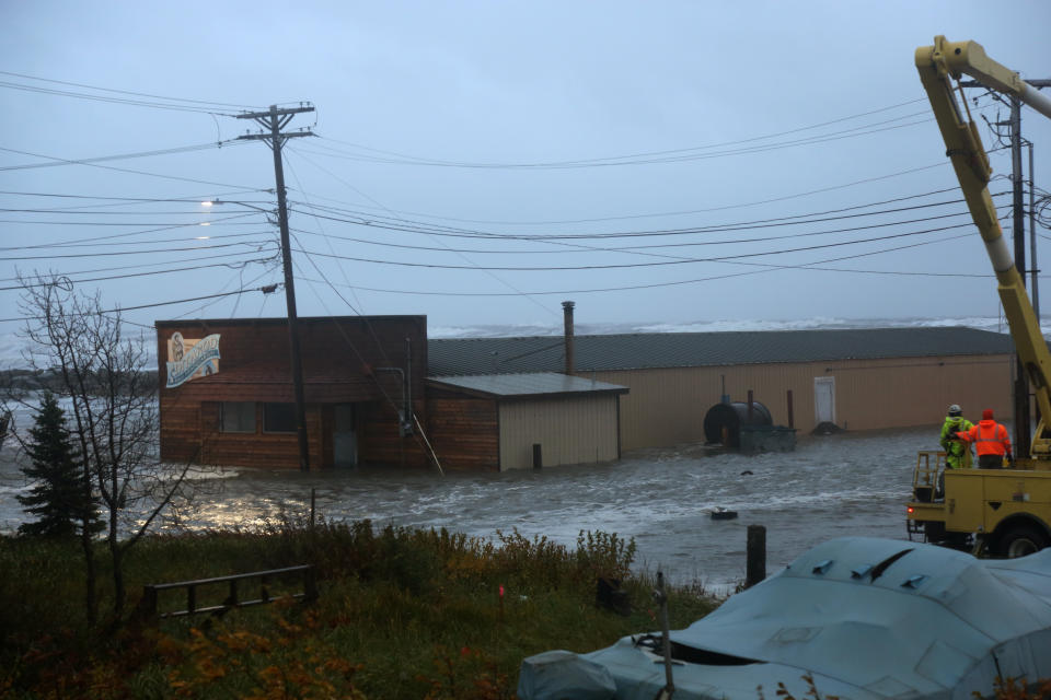 Water surrounds the mini convention center, which is also home to the finish of the Iditarod Trail Sled Dog Race, in Nome, Alaska, on Saturday, Sept. 17, 2022. Much of Alaska's western coast could see flooding and high winds as the remnants of Typhoon Merbok moved into the Bering Sea region. The National Weather Service says some locations could experience the worst coastal flooding in 50 years. (AP Photo/Peggy Fagerstrom)