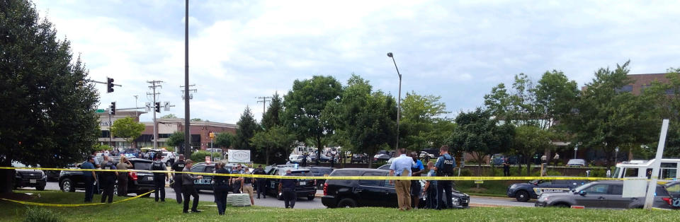 Police officers respond to an active shooter inside a building that houses the Capital Gazette newsroom in Annapolis, Maryland.