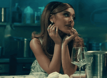 Ariana Grande singing on kitchen counter