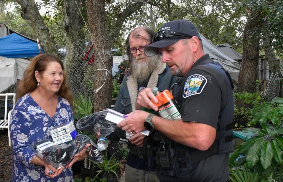 Palm Bay Community Resource Officers Dave Porter (seen here) and Ryan Austin check on a homeless couple, taking them supplies including new socks, insect repellent and water donated by area churches and individuals.