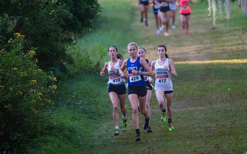 Sienna Audrey from Community School of Naples leads the FHSAA Girls Region 1A-R3 Cross Country Championship at Holloway Park in Lakeland on Thursday, Nov. 9, 2023. She won and led her team to a second place finish.