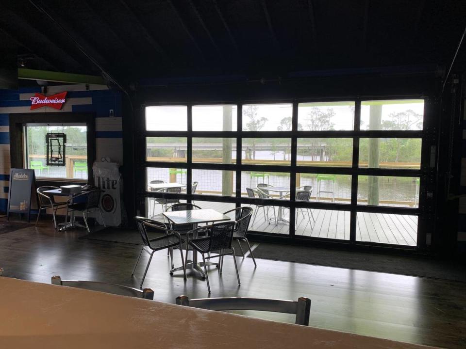 A garage door with windows to capture the views rolls open to let in the breeze from the river at the new at Pier 15 restaurant and entertainment venue. Mary Perez/meperez@sunherald.com
